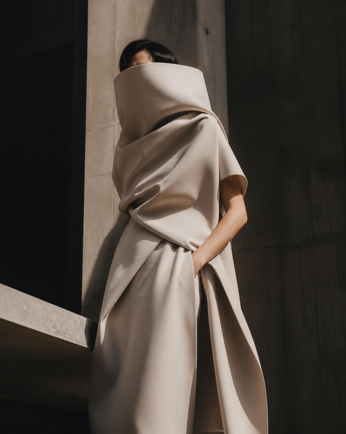 Sculptural garment against concrete